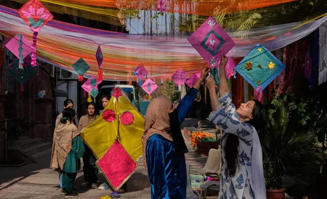 Students decorate their university campus with variety of kites ahead of the upcoming three-day kite flying festival 'Basant' celebrations, in Lahore, Pakistan, Thursday, Feb. 5, 2026. (AP Photo/K.M. Chaudary)