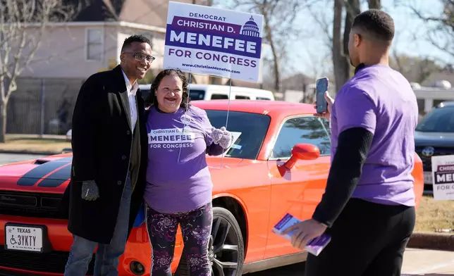 Texas Congressional Candidate Christian D. Menefee gets a photo with poll worker, Jessica Barraza, as he visited a polling location at Acres Homes MultiService Center on Election Day, in Houston, Saturday, Jan. 31, 2026. (AP Photo/ Karen Warren)