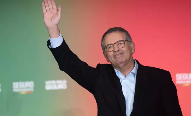 Presidential candidate Antonio Jose Seguro, of the center-left Socialist Party, waves to the crowd during a campaign rally ahead of the Feb. 8 presidential election in Lisbon, Thursday, Feb. 5, 2026. (AP Photo/Ana Brigida)
