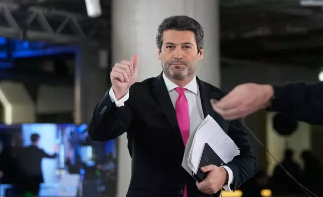 Presidential candidate Andre Ventura, of the populist Chega party, arrives for a television debate with opponent Antonio Jose Seguro, of the center-left Socialist Party, ahead of the Feb. 8 presidential election, in Lisbon, Tuesday, Jan. 27, 2026. (AP Photo/Armando Franca)