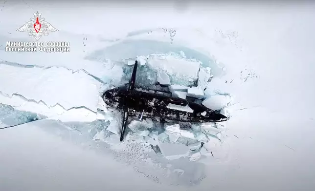 FILE - This photo taken from video released on March 26, 2021 by the Russian Defense Ministry press service shows a Russian nuclear submarine breaking through the Arctic ice during military drills at an unspecified location. (Russian Defense Ministry Press Service via AP, File)