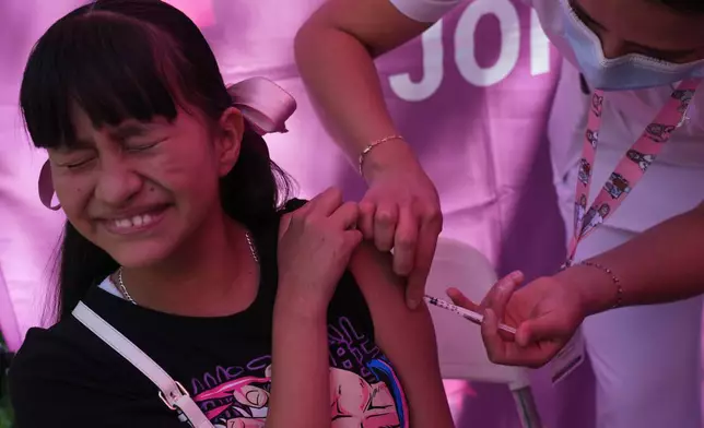 A health worker administers a dose of the measles vaccine in Chapultepec Park in Mexico City, Sunday, Feb. 8, 2026. (AP Photo/Marco Ugarte)