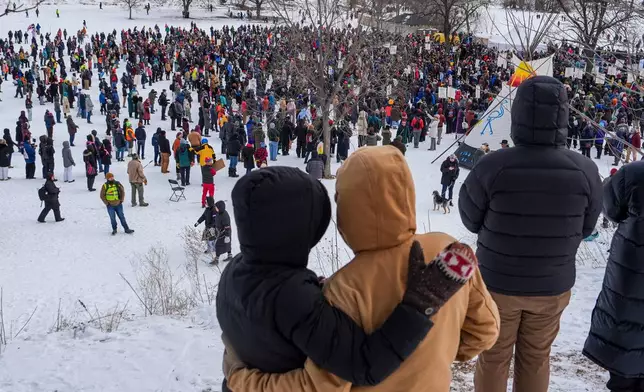 People gather for a memorial honoring Renee Good, who was fatally shot by a federal agent, in Minneapolis, Saturday, Feb. 7, 2026, . (AP Photo/Ryan Murphy)