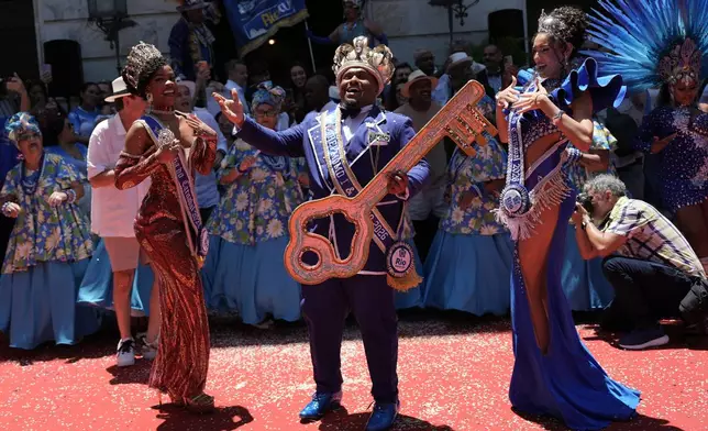 Carnival King Momo, Danilo Vieira, dances after receiving the keys to the city at a ceremony officially kicking off Carnival in Rio de Janeiro, Friday, Feb. 13, 2026. (AP Photo/Silvia Izquierdo)