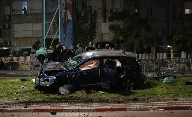 Israeli police investigate a deadly crime scene in the mixed Arab-Jewish town of Lod in central Israel, where a gunman fired on a car, killing one person and injuring two others, Saturday, Jan. 31, 2026. (AP Photo/Mahmoud Illean)
