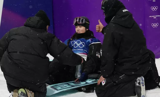South Korea's Choi Ga-on celebrates with team members after her run during the women's snowboarding halfpipe finals at the 2026 Winter Olympics, in Livigno, Italy, Thursday, Feb. 12, 2026. (AP Photo/Lindsey Wasson)