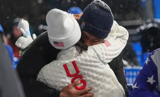 United States' Chloe Kim and Cleveland Browns' Myles Garrett hug after Kim won the silver medal in the women's snowboarding halfpipe finals at the 2026 Winter Olympics, in Livigno, Italy, Thursday, Feb. 12, 2026. (AP Photo/Lindsey Wasson)