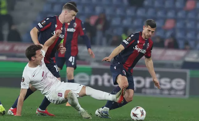 Bologna's Lewis Ferguson, right, battles for the ball with Brann's Felix Horn Myhre during a Europa League soccer match between Bologna and Brann, Thursday, Feb. 26, 2026, in Bologna, Italy. (Gianni Santandrea/LaPresse via AP)