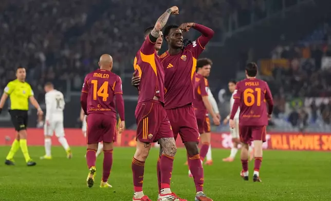 Roma's Evan Ndicka and Roma's Gianluca Mancini celebrates after scoring during the Serie A soccer match between Roma and Cremonese in Rome, Italy, Sunday Feb. 22, 2026. (Alfredo Falcone/LaPresse via AP)