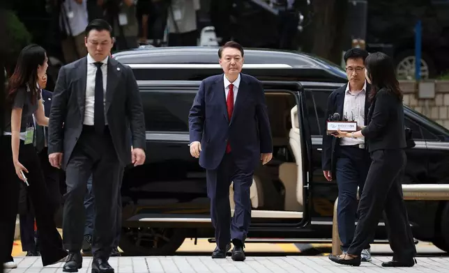 FILE - Former South Korean President Yoon Suk Yeol, centerm arrives at a court to attend a hearing to review his arrest warrant requested by special prosecutors in Seoul, South Korea, July 9, 2025. (Kim Hong-Ji/Pool Photo via AP, File)