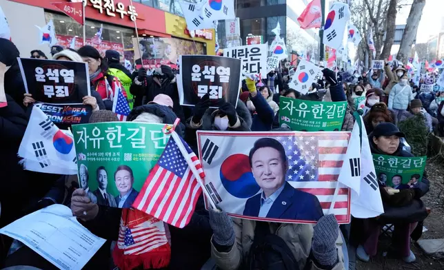 Supporters of former South Korean President Yoon Suk Yeol stage a rally outside of Seoul Central District Court in Seoul, South Korea, Thursday, Feb. 19, 2026. (AP Photo/Ahn Young-joon)