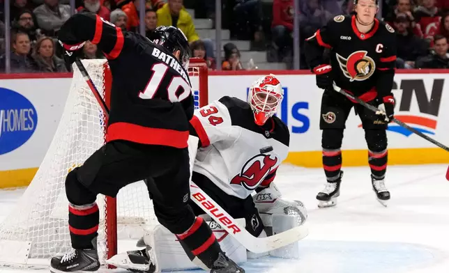 Ottawa Senators' Drake Batherson (19) looks for a chance against New Jersey Devils goaltender Jake Allen (34) during the second period of an NHL hockey game in Ottawa, on Saturday, Jan. 31, 2026. (Justin Tang/The Canadian Press via AP)