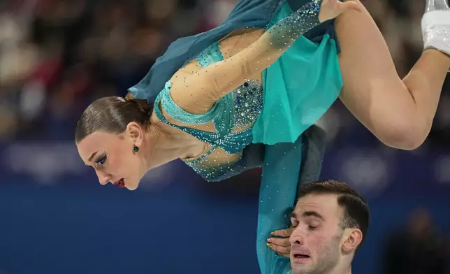 Anastasiia Metelkina and Luka Berulava of Georgia compete during the pairs figure skating long program at the 2026 Winter Olympics, in Milan, Italy, Monday, Feb. 16, 2026. (AP Photo/Francisco Seco)