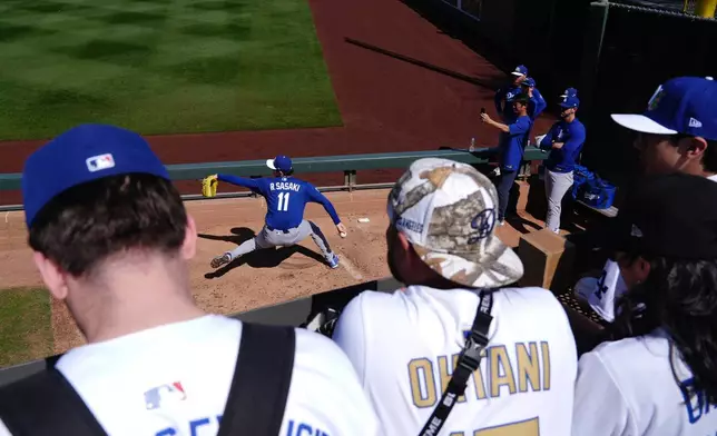 Los Angeles Dodgers starting pitcher Roki Sasaki, of Japan, warms up prior to a spring training baseball game against the Arizona Diamondbacks Wednesday, Feb. 25, 2026, in Scottsdale, Ariz. (AP Photo/Ross D. Franklin)