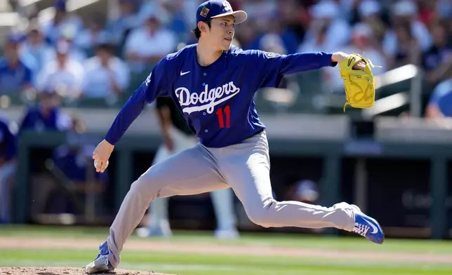 Los Angeles Dodgers starting pitcher Roki Sasaki, of Japan, throws against the Arizona Diamondbacks during the first inning of a spring training baseball game Wednesday, Feb. 25, 2026, in Scottsdale, Ariz. (AP Photo/Ross D. Franklin)