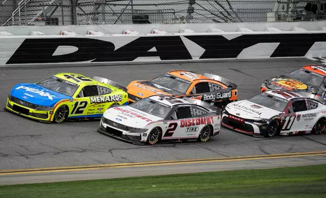 Cars move during the NASCAR Daytona 500 auto race at Daytona International Speedway, Sunday, Feb. 15, 2026, in Daytona Beach, Fla. (AP Photo/Mike Stewart)