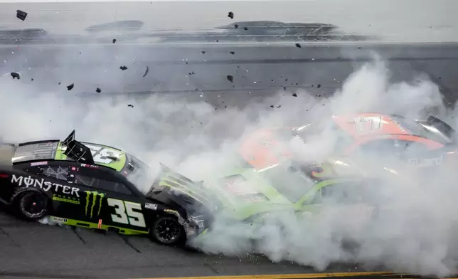 Riley Herbst, (35) and others crash on the checkered flag during the NASCAR Daytona 500 auto race at Daytona International Speedway, Sunday, Feb. 15, 2026, in Daytona Beach, Fla. (AP Photo/John Raoux)