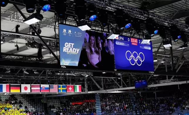 Fans are seen on a screen during an intermission of a preliminary round match of women's ice hockey between Japan and Sweden at the 2026 Winter Olympics, in Milan, Italy, Tuesday, Feb. 10, 2026. (AP Photo/Petr David Josek)