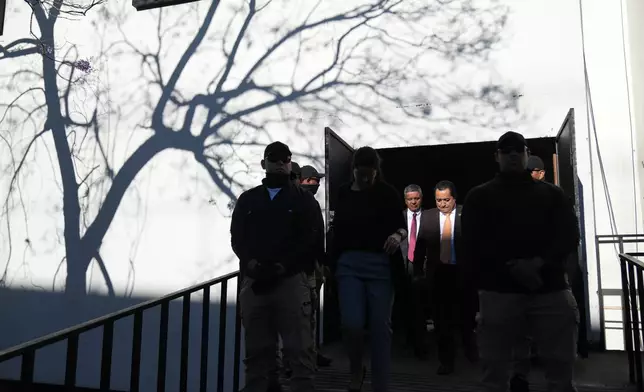 Lawyers leave after voting in an election of magistrates to represent the bar association on the Constitutional Court in Guatemala City, Thursday, Feb. 12, 2026. (AP Photo/Moises Castillo)