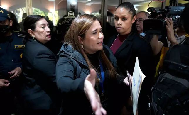 Attorney General prosecutor Leonor Morales, center, leads a raid at Club La Aurora where Bar Association members were meeting to vote for representatives to serve on the Constitutional Court, in Guatemala City, Thursday, Feb. 12, 2026.(AP Photo/Moises Castillo)