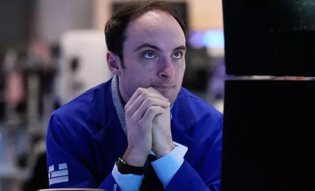 Specialist Joseph Maguire works at his post on the floor of the New York Stock Exchange, Tuesday, Feb. 3, 2026. (AP Photo/Richard Drew)