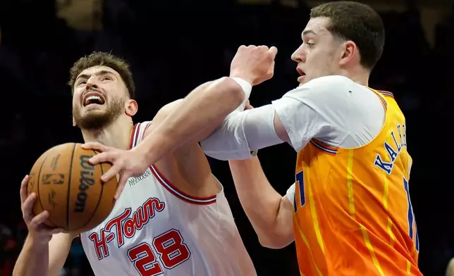 Houston Rockets center Alperen Sengun (28) looks to shoot against Charlotte Hornets center Ryan Kalkbrenner, right, during the first half of an NBA basketball game in Charlotte, N.C., Thursday, Feb. 19, 2026. (AP Photo/Nell Redmond)