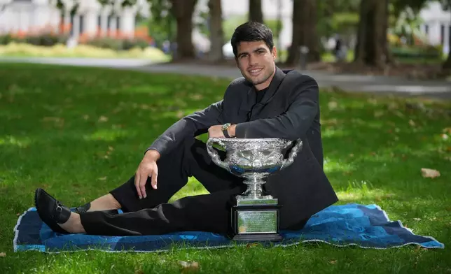 Carlos Alcaraz of Spain poses with the Norman Brookes Challenge Cup the morning after defeating Novak Djokovic of Serbia in the men's singles final at the Australian Open tennis championship, in Melbourne, Australia, Monday, Feb. 2, 2026. (AP Photo/Dita Alangkara)