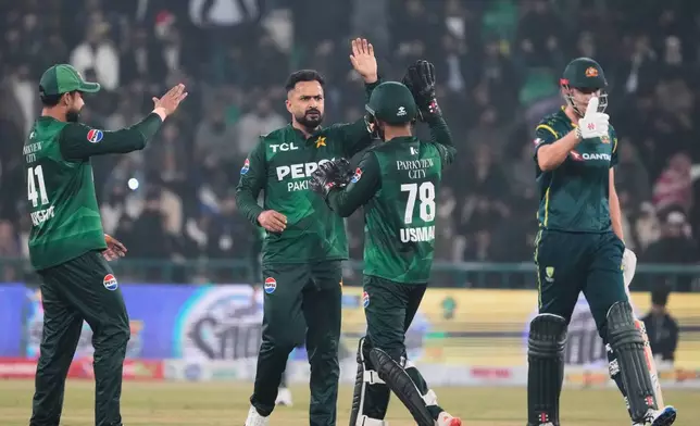 Pakistan's Mohammad Nawaz, center, celebrates with teammates after the dismissal of Australia's Matt Renshaw during the second T20 cricket match between Pakistan and Australia, in Lahore, Pakistan, Saturday, Jan. 31, 2026. (AP Photo/K.M. Chaudary)