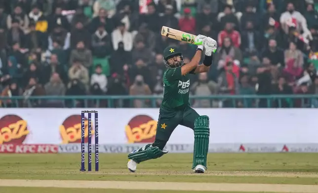 Pakistan's Babar Azam follows the ball after playing a shot during the third T20 cricket match between Pakistan and Australia, in Lahore, Pakistan, Sunday, Feb. 1, 2026. (AP Photo/K.M. Chaudary)
