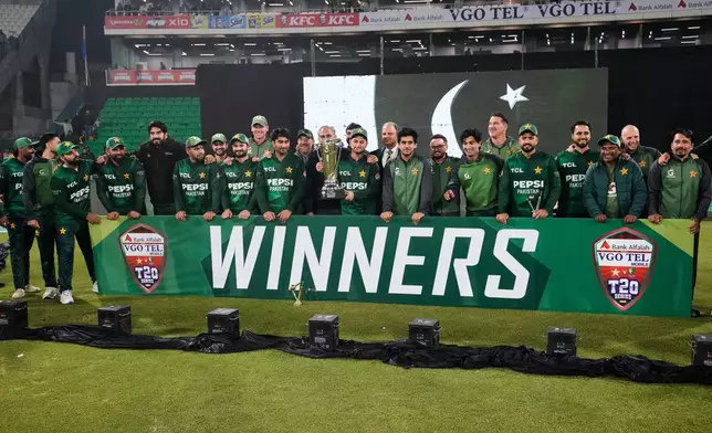 Pakistani players and official pose for photograph with the trophy after winning the T20 series against Australia on the end of the third T20 cricket match between Pakistan and Australia, in Lahore, Pakistan, Sunday, Feb. 1, 2026. (AP Photo/K.M. Chaudary)