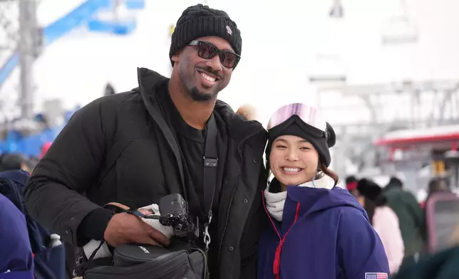 Cleveland Browns' Myles Garrett, left, and United States' Chloe Kim smile after the women's snowboarding halfpipe qualifications at the 2026 Winter Olympics, in Livigno, Italy, Wednesday, Feb. 11, 2026. (AP Photo/Lindsey Wasson)