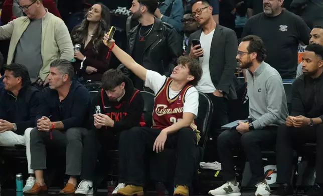 NBA fans sit courtside during the first half of an NBA basketball game between the Phoenix Suns and the Cleveland Cavaliers, Friday, Jan. 30, 2026, in Phoenix. (AP Photo/Ross D. Franklin)