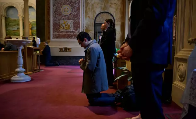 A parishioner kneels during prayer, during an Ash Wednesday Mass at the Cathedral of St. Matthew the Apostle, Wednesday, Feb., 18, 2026, in Washington. (AP Photo/Rod Lamkey, Jr.)