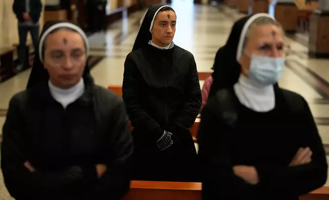 Nuns attend Ash Wednesday Mass after getting the form of a cross marked on their foreheads at the Divine Child Church in Bogota, Colombia, Wednesday, Feb. 18, 2026, the start of the Christian season of Lent, a period of penitence and reflection that leads up to Easter. (AP Photo/Fernando Vergara)