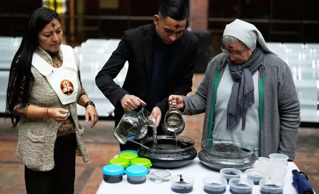 Catholic Sacristan Santiago Moreno, center, Sister Diva Camacho, right, and Lay Minister Yolanda Carrillo prepare ashes that will mark people's foreheads during Ash Wednesday Mass at the Divine Child Church in Bogota, Colombia, Wednesday, Feb. 18, 2026, the start of the Christian season of Lent, a period of penitence and reflection that leads up to Easter. (AP Photo/Fernando Vergara)