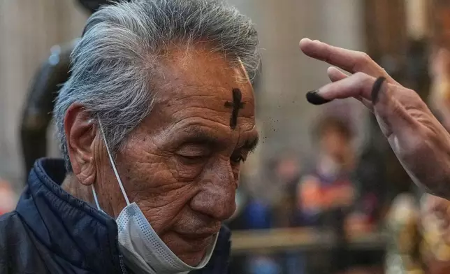 A parishioner receives ashes on Ash Wednesday in Mexico City, Wednesday, Feb. 18, 2026. (AP Photo/Marco Ugarte)