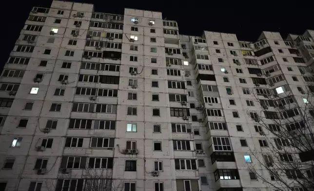 An apartment block is seen during a power outage caused by Russia’s repeated air strikes on the country’s power grid, in Kyiv, Ukraine, Monday, Feb. 2, 2026. (AP Photo/Sergey Grits)