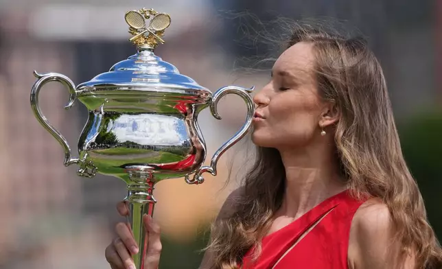 Elena Rybakina of Kazakhstan poses with Daphne Akhurst Memorial Cup on the banks of the Yarra River the morning after defeating Aryna Sabalenka of Belarus in the women's singles final at the Australian Open tennis championship in Melbourne, Australia, Sunday, Feb. 1, 2026. (AP Photo/Dita Alangkara)
