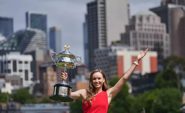 Elena Rybakina of Kazakhstan poses with Daphne Akhurst Memorial Cup on the banks of the Yarra River the morning after defeating Aryna Sabalenka of Belarus in the women's singles final at the Australian Open tennis championship in Melbourne, Australia, Sunday, Feb. 1, 2026. (AP Photo/Dita Alangkara)