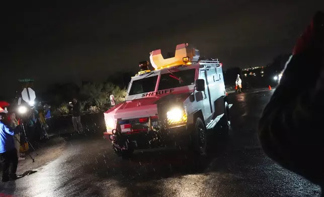 Pima County Sheriff block a road near Nancy Guthrie's home in Tucson, Ariz. on Friday, Feb. 13, 2026. (AP Photo/Ty ONeil)