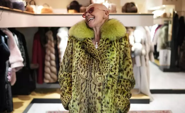 Paola De Leidi poses for a photo wearing a fur coat after an interview with The Associated Press in the Pajaro shop, in Cortina d'Ampezzo, Italy, Saturday, Feb. 14, 2026. (AP Photo/Alessandra Tarantino)