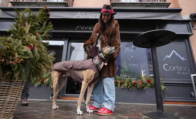 Cecilia Secondin poses with her dog Porter in Cortina d'Ampezzo, Italy, Saturday, Feb. 14, 2026. (AP Photo/Alessandra Tarantino)