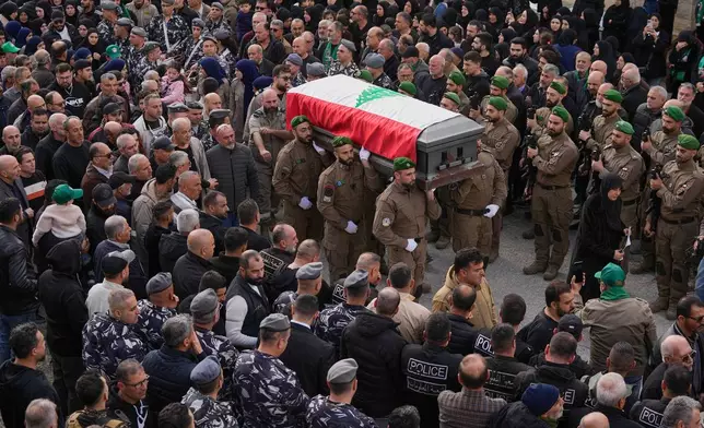 Lebanese special forces policemen carry the coffins of their comrade Hassan Jaber, 38, who was killed on Monday with his son Ali, 4, by an Israeli drone attack, during their funeral procession in Yanouh village, south Lebanon, Tuesday, Feb. 10, 2026. (AP Photo/Mohammed Zaatari)