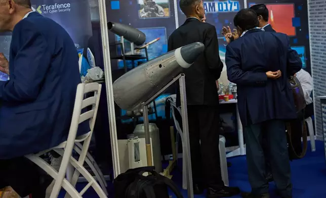 Visitors attend a defense industry exhibition in Tel Aviv, Israel, Tuesday, Feb. 17, 2026. (AP Photo/Oded Balilty)