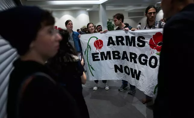 Activists protest against a defense industry exhibition in Tel Aviv, Israel, Tuesday, Feb. 17, 2026. (AP Photo/Oded Balilty)