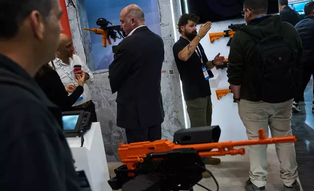 Visitors attend a defense industry exhibition in Tel Aviv, Israel, Tuesday, Feb. 17, 2026. (AP Photo/Oded Balilty)