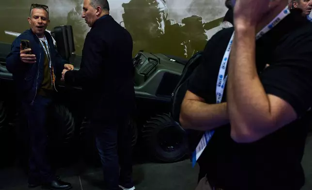 Visitors attend a defense industry exhibition in Tel Aviv, Israel, Tuesday, Feb. 17, 2026. (AP Photo/Oded Balilty)