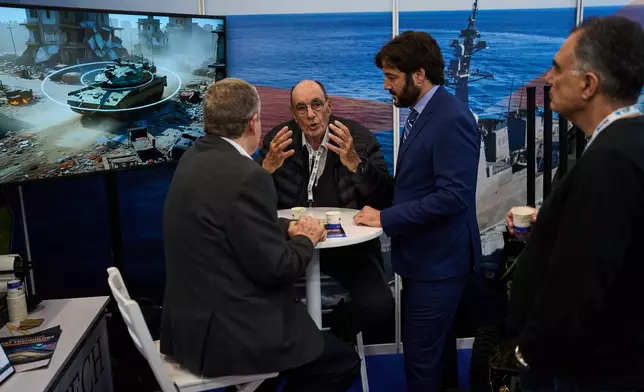 Visitors attend a defense industry exhibition in Tel Aviv, Israel, Tuesday, Feb. 17, 2026. (AP Photo/Oded Balilty)