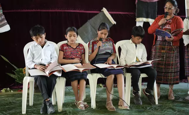 Students read books in the Mayan language at a school in San Jose Poaquil, Guatemala, Thursday, Guatemala Feb. 19, 2026, ahead of International Mother Language Day. (AP Photo/Emmanuel Andres)