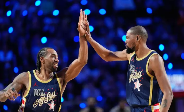 USA Stripes forward Kawhi Leonard, left, celebrates with forward Kevin Durant after scoring against World during the NBA All-Star basketball game Sunday, Feb. 15, 2026, in Inglewood, Calif. (AP Photo/Mark J. Terrill)